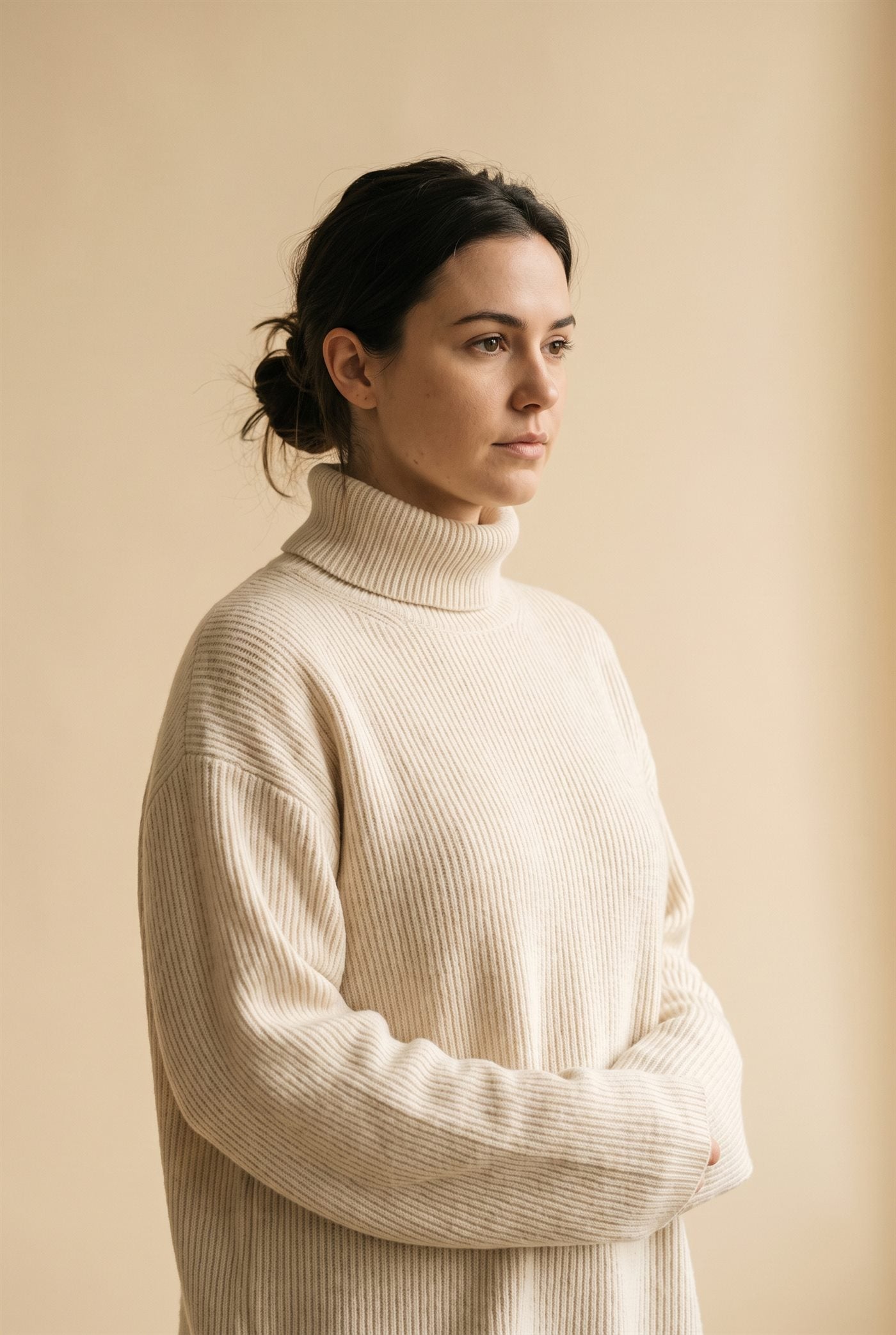 Woman wearing a cream ribbed knit sweater